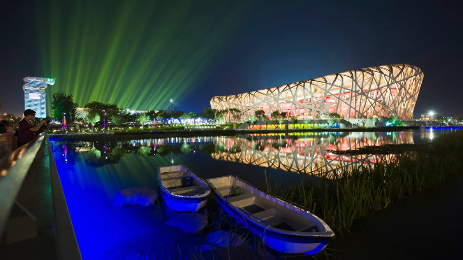Exterior of Beijing National Stadium bird's nest-shaped building lit up at night