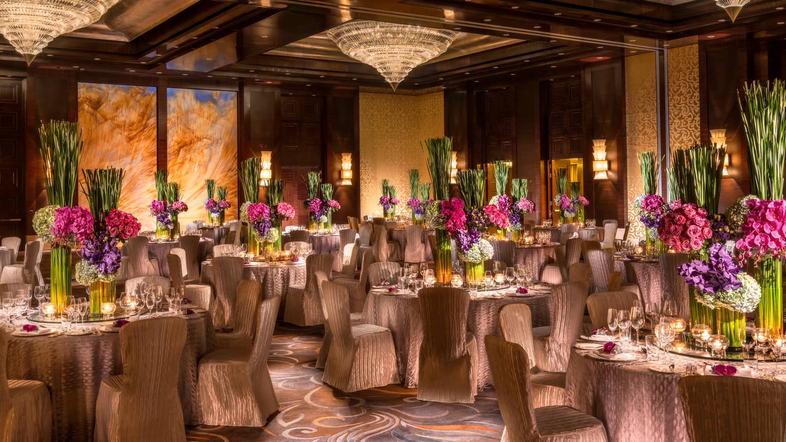 Imperial Ballroom wedding reception with fabric-covered chairs, floral centrepieces, crystal chandeliers